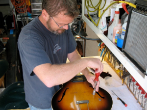 Jim Crawford prepping an archtop for a re-fret and set up.
